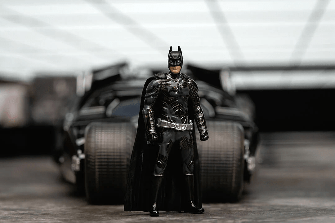 JAD34821 Batman: Dark Knight Trilogy - Batmobile with Batman (Black Camo) SDCC 2023 Exclusive 1:24 Scale - Jada Toys - Titan Pop Culture